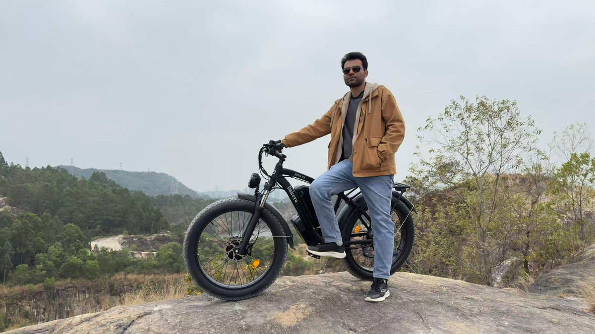 Rider with a Dakeya fat tire electric bike on a hillside