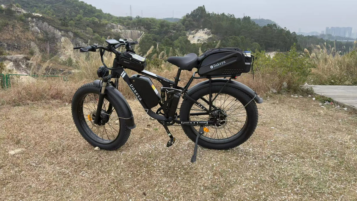Dakeya DA03 fat-tire electric bike with rear rack and cargo bag in a rugged outdoor setting